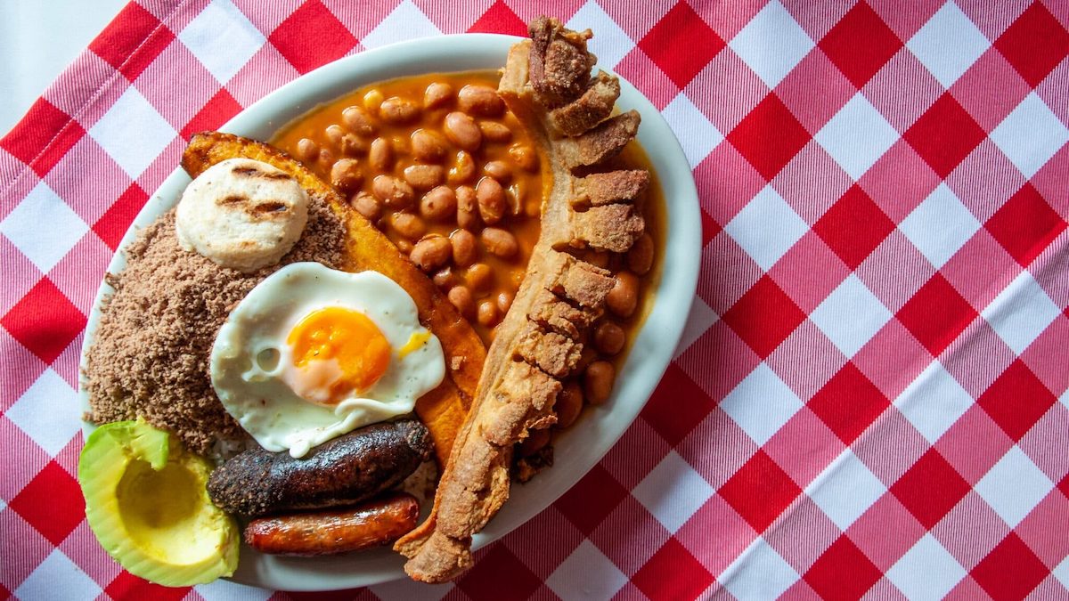 Bandeja paisa, typical dish at the Antioquia region of Colombia. It consists of chicharrón (fried pork belly), black pudding, sausage, arepa, beans, fried plantain, avocado egg, and rice.