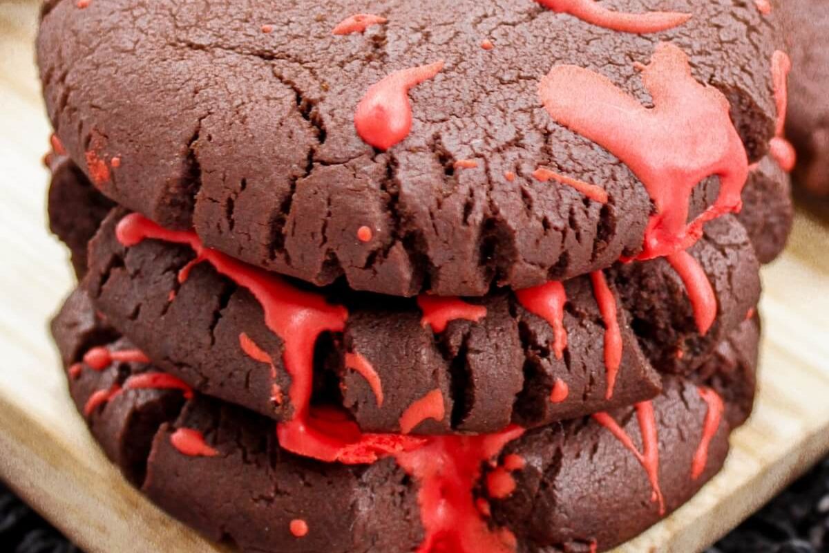 A tray of chocolate cookies with frosting blood splatter.