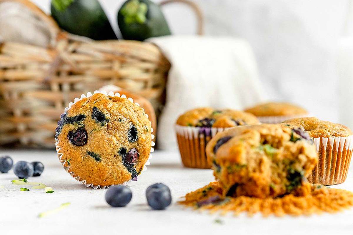 Blueberry zucchini muffins on a table.