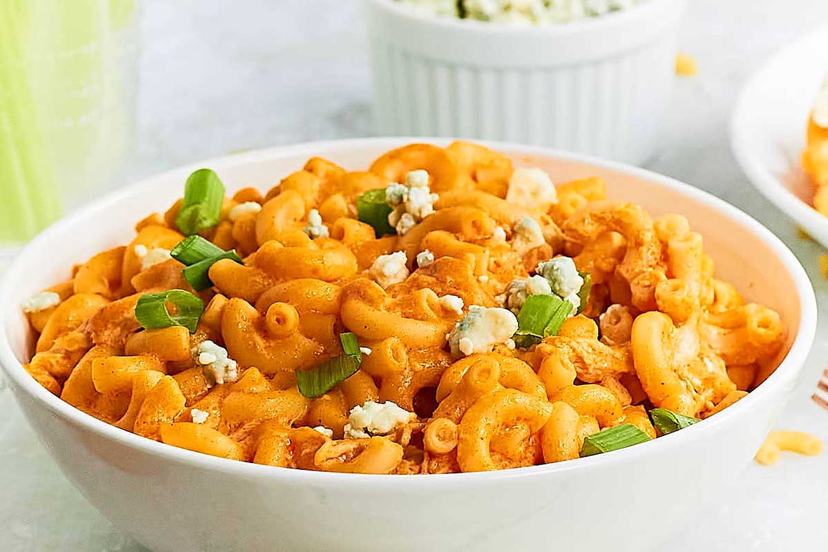 Buffalo chicken mac and cheese with fresh herbs on top.