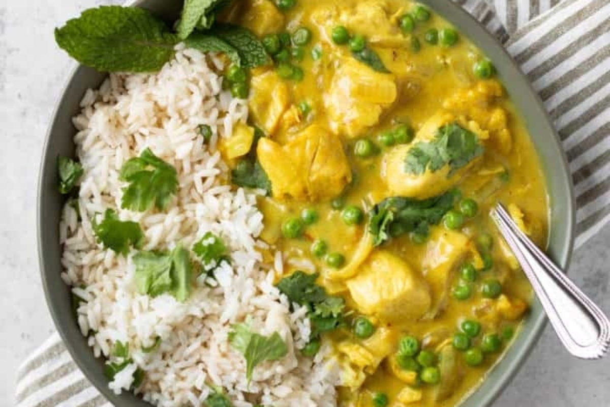 Chicken curry with rice in a green bowl.
