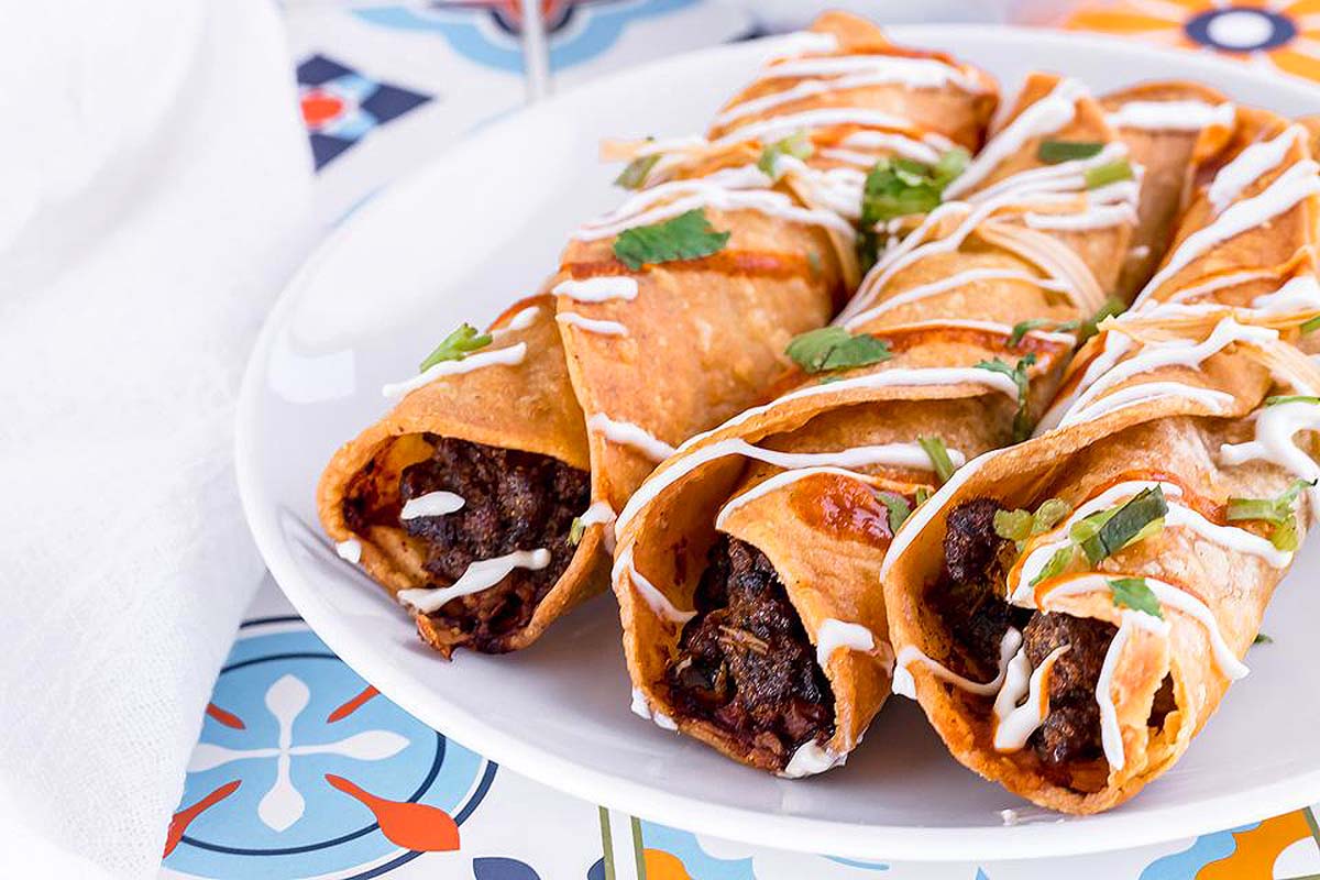 Homemade beef taquitos on a plate.