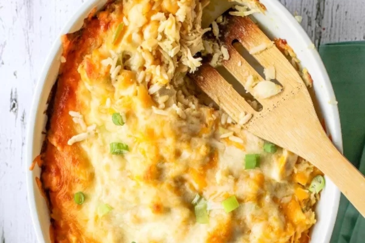 Chicken and rice casserole with wooden spoon.