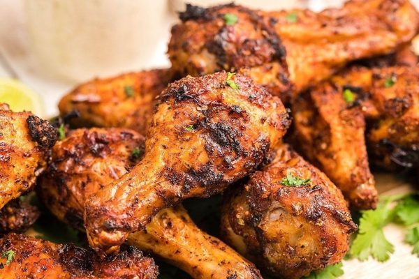 Air fryer chicken wings with sauce.
