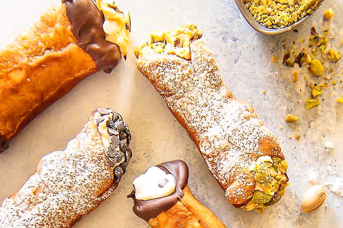 Cannoli filled with flavored ricotta cheese and different toppings.