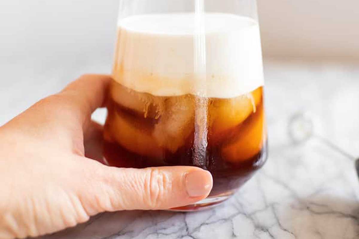 Cold foam coffee drink topping in a glass.