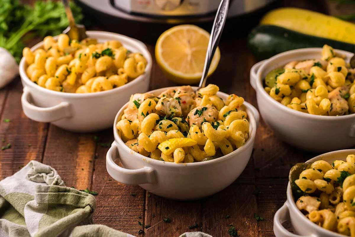 Instant pot macaroni and cheese in white bowls on a wooden table.