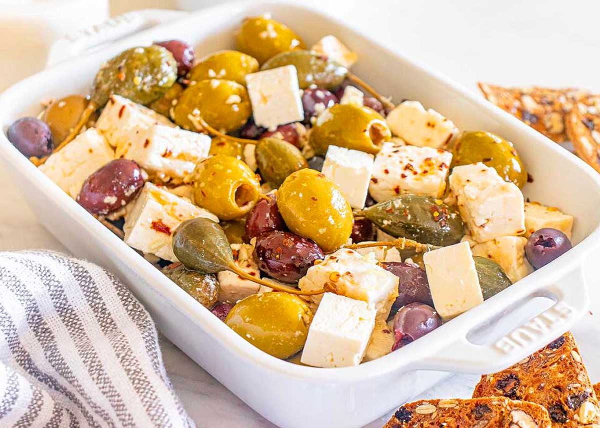 Marinated Olives with Feta in a white dish.