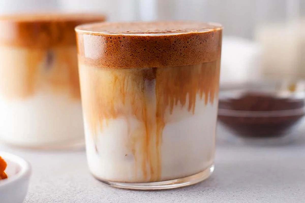 Pumpkin spice whipped coffee in a glass cup. 