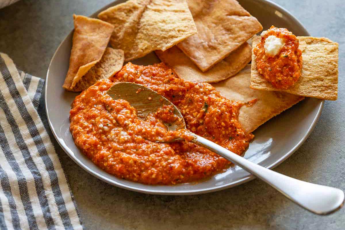 Red pepper dip with chips.
