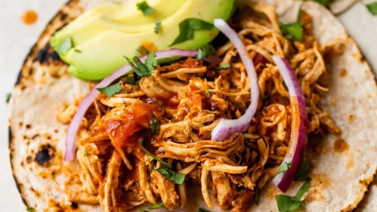 A slow cooker chicken taco on a plate.