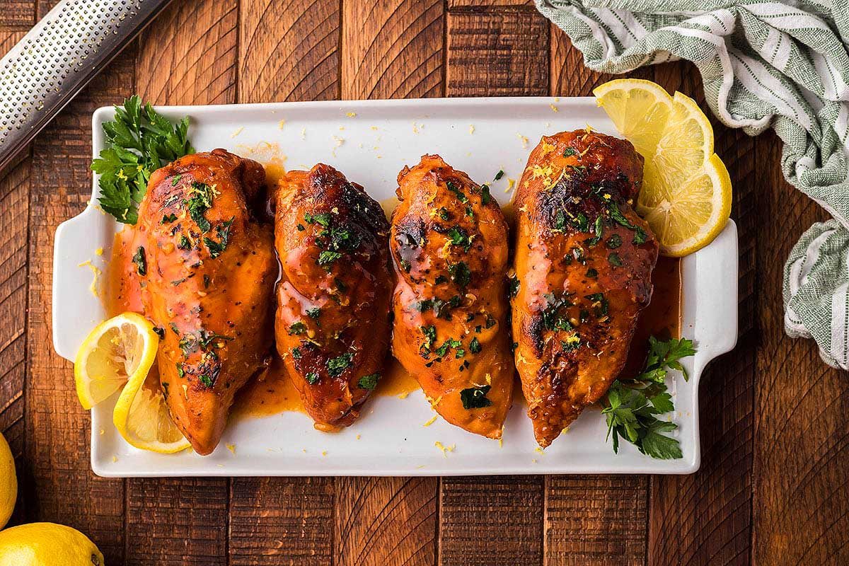Chicken breasts on white tray.
