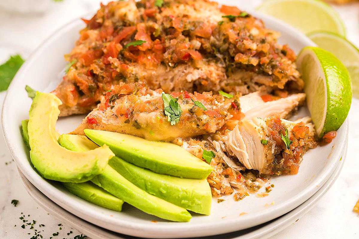 Salsa fresca chicken breast on a plate with avocado.