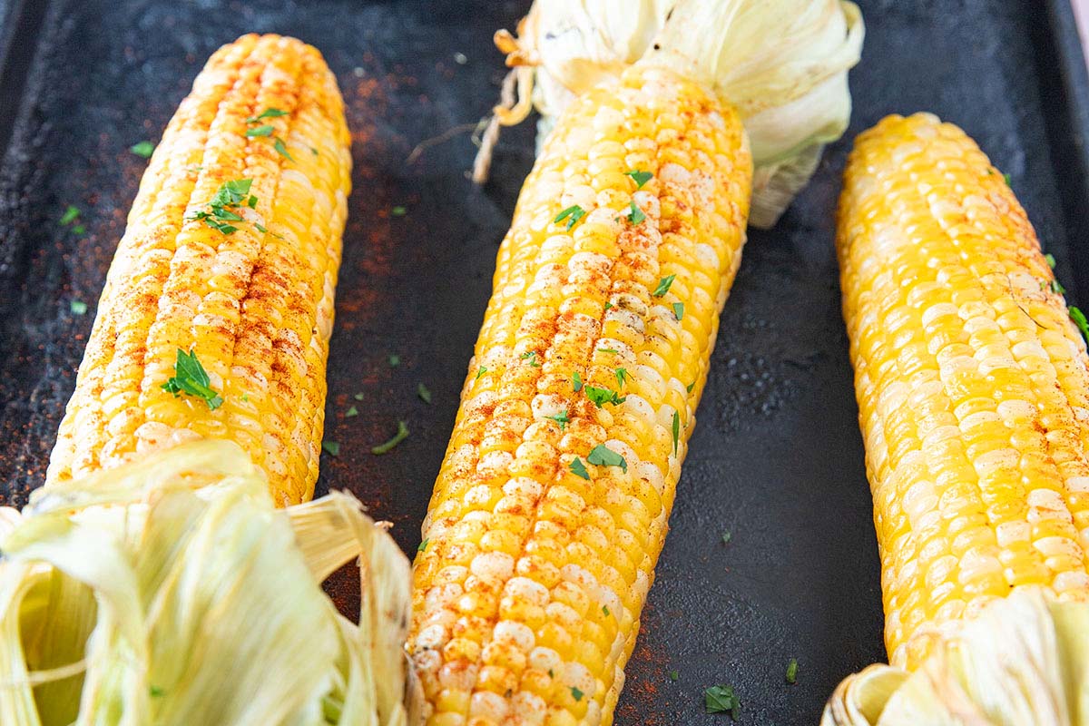 Three ears of corn that have been smoked. 