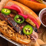 A smoky bbq brisket sandwich with jalapenos and a tangy ketchup twist.
