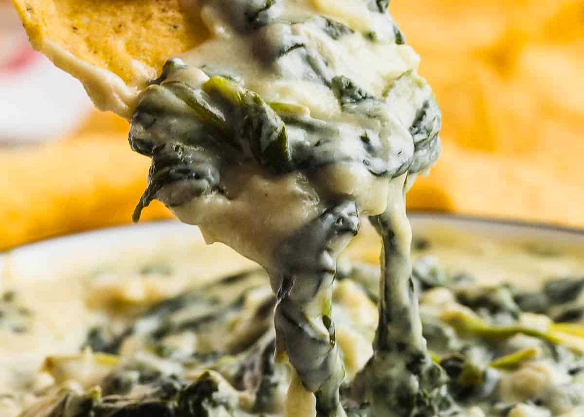 A homemade hot spinach dip served with chips.