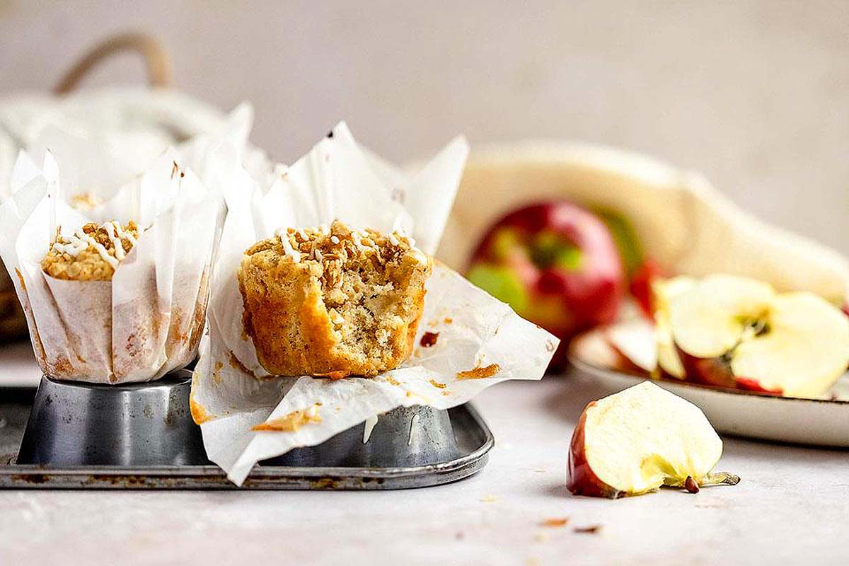 Apple muffins in parchment paper liners.