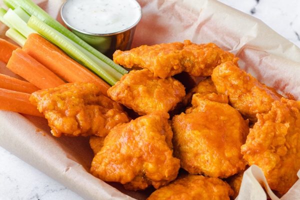 Game Day Wings in a basket with carrots and celery.