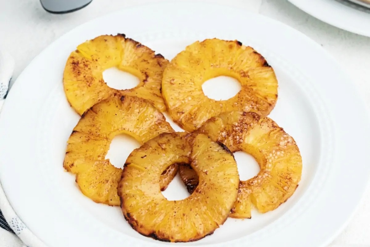 Hawaiian-inspired pineapple rings on a white plate.