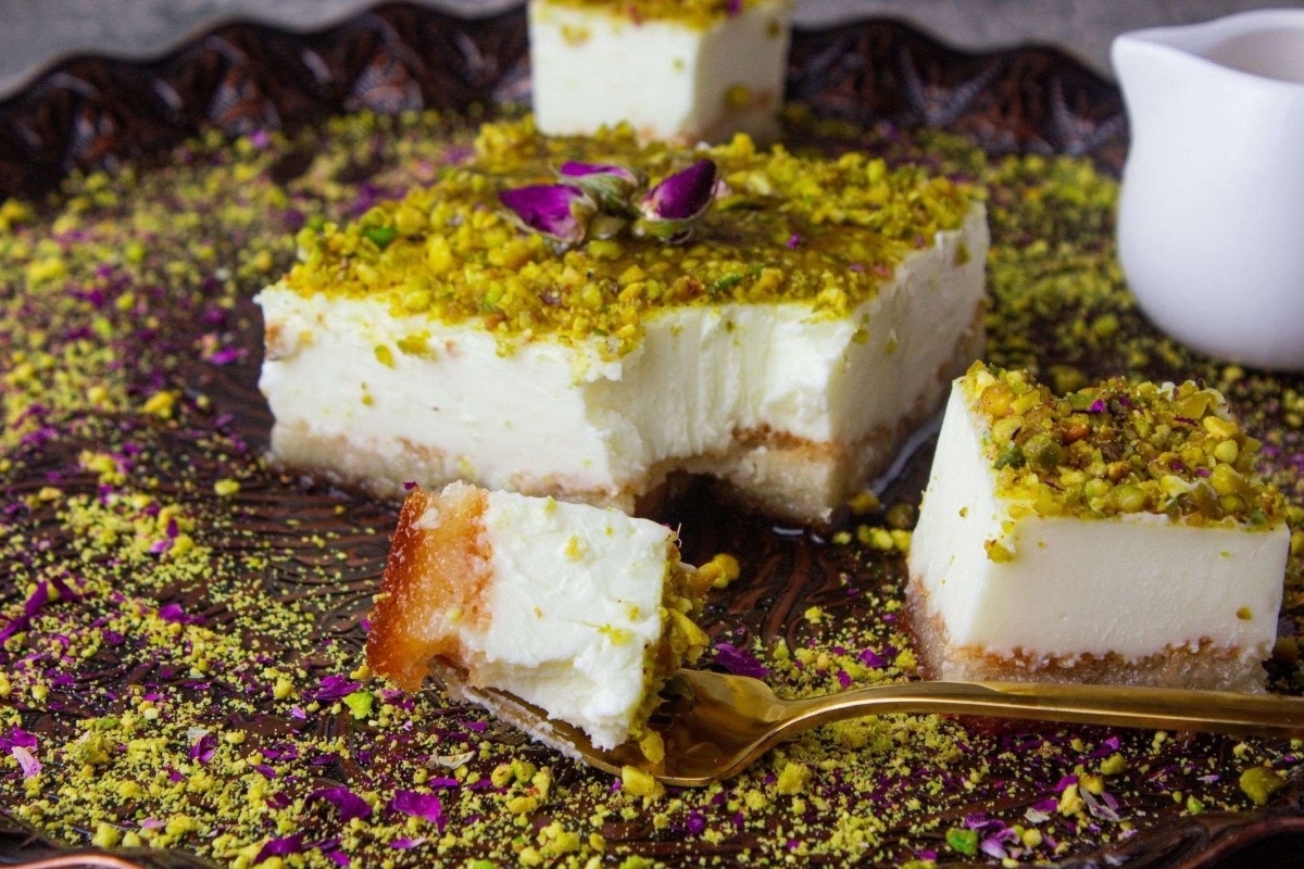Pistachio cheesecake with pistachios on a plate - a delectable dessert made from pistachios, is the perfect addition to your collection of pistachio recipes.