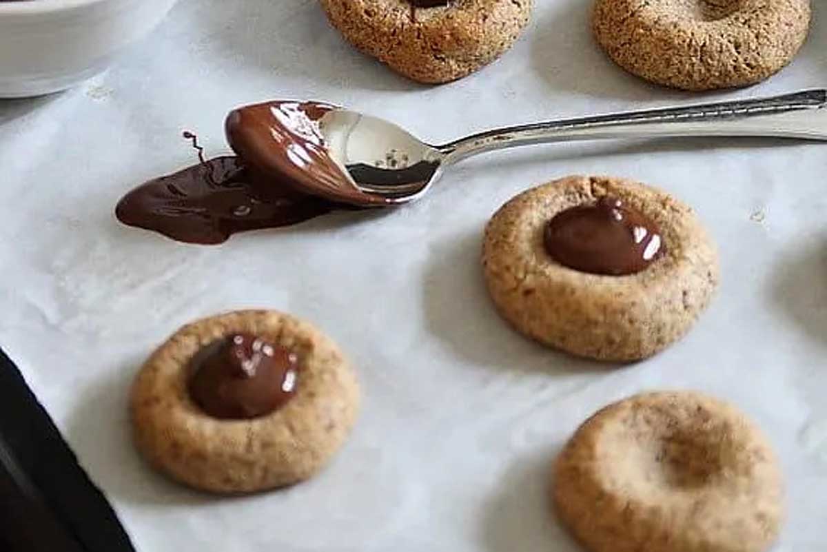 Almond Chocolate Thumbprint Cookies with chocolate center.
