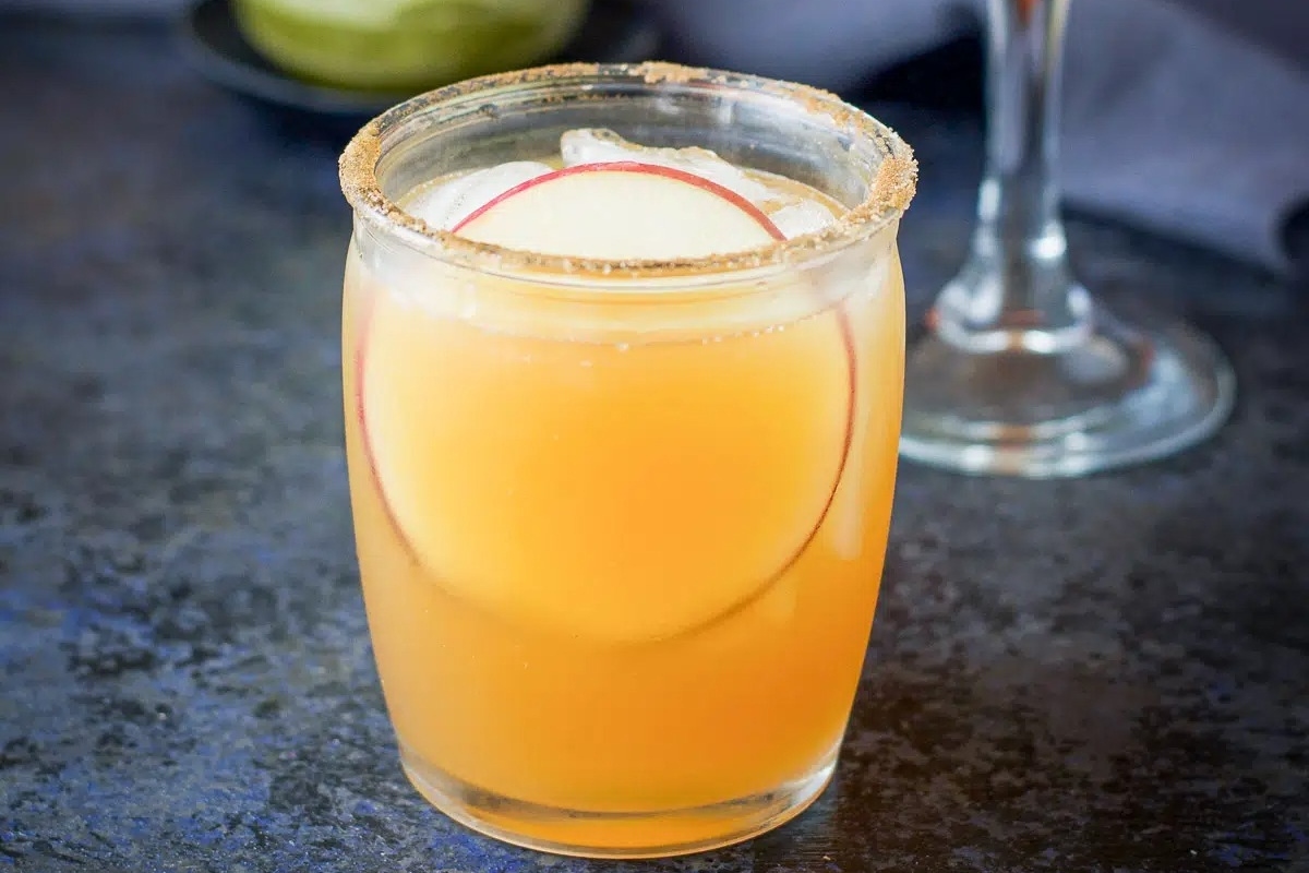 22 Amazing Apple Cider Recipes You Have to Try 22 An inviting glass of apple cider garnished with a fresh slice of apple.