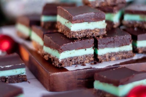 A stack of mint chocolate bars on a wooden board.