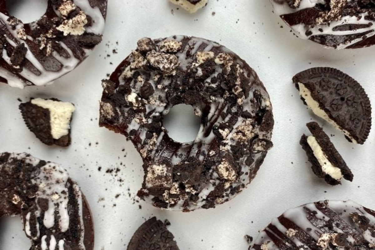 Indulge in mouthwatering Oreo cookie doughnuts topped with decadent chocolate icing, perfect for Christmas celebrations.