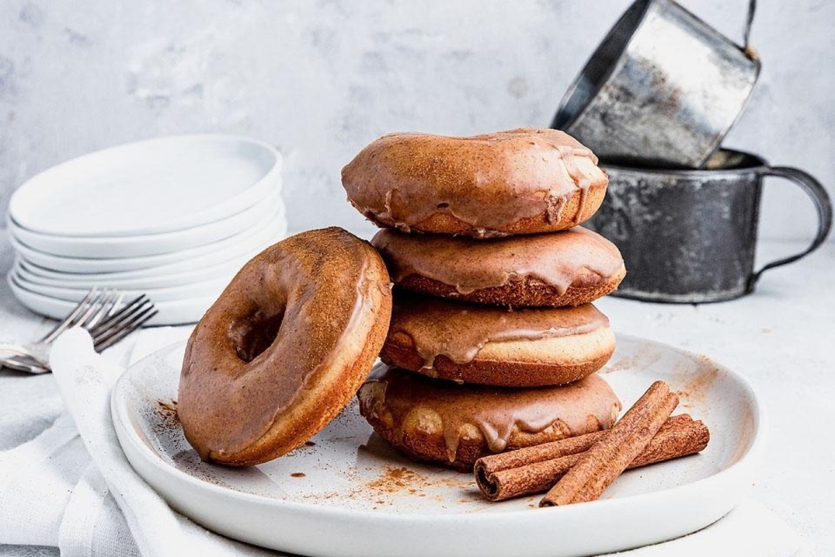 A stack of cinnamon donuts on a plate.