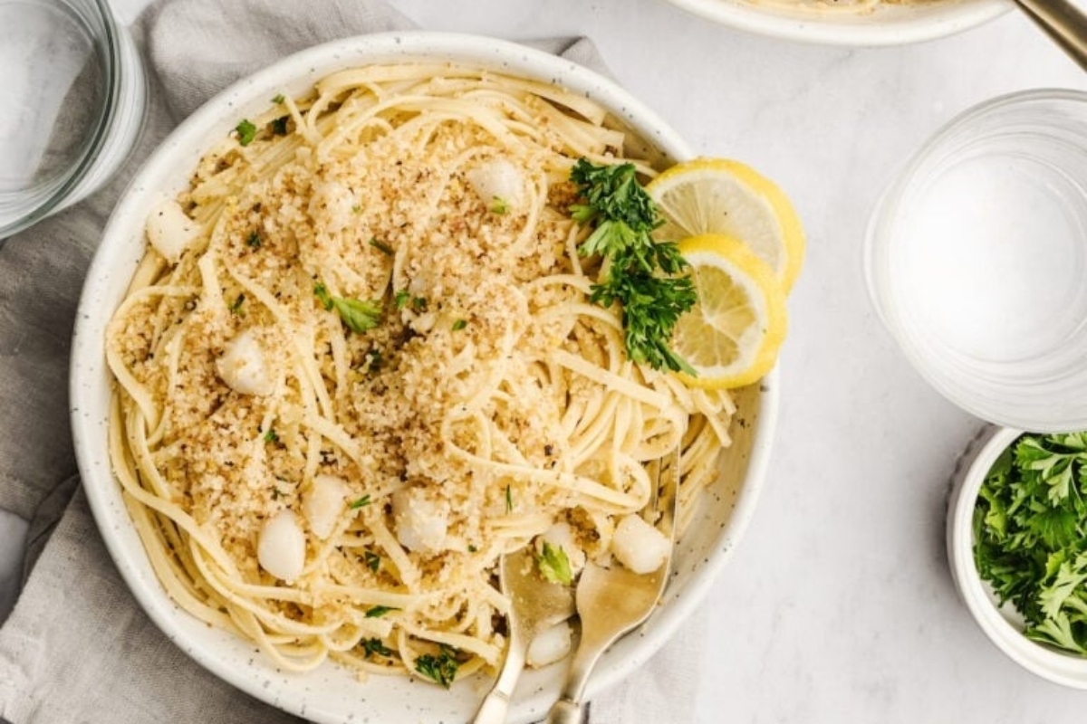 A delightful bowl of pasta infused with the zesty flavors of lemon and sprinkled with fresh parsley.