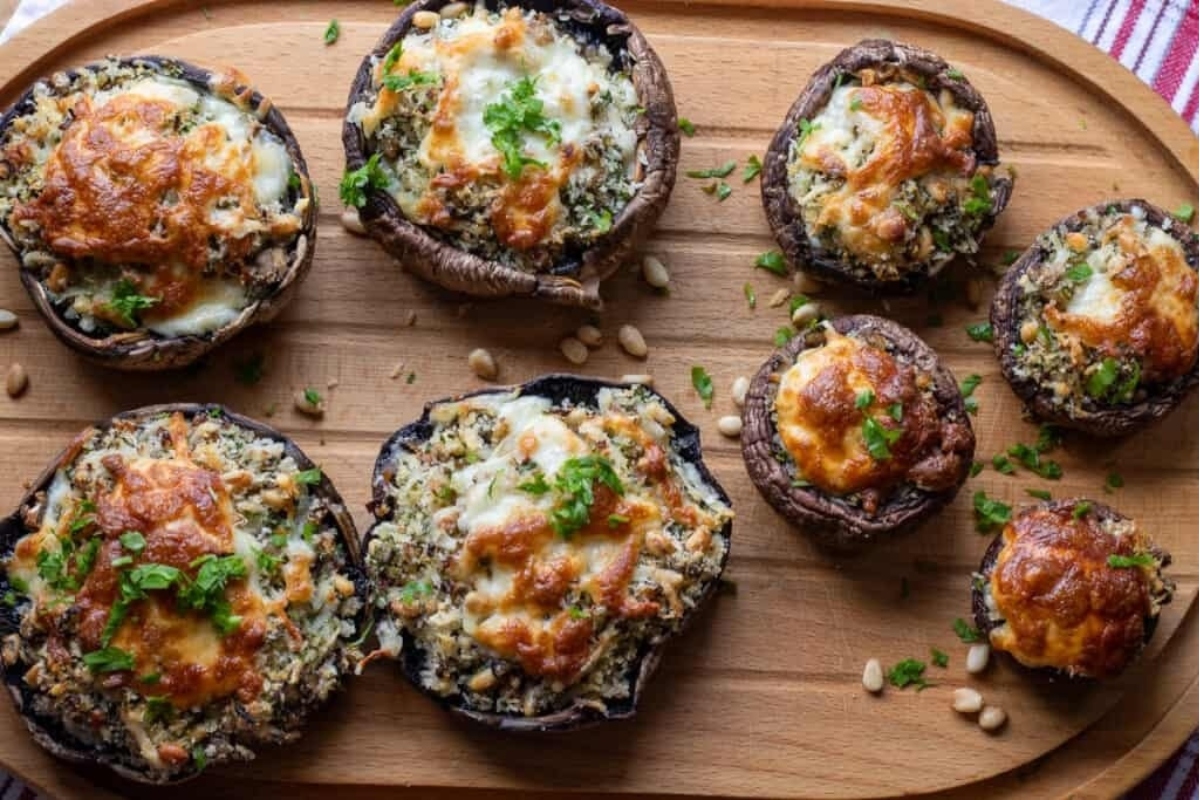 Christmas party appetizer - Stuffed mushrooms beautifully presented on a wooden cutting board.