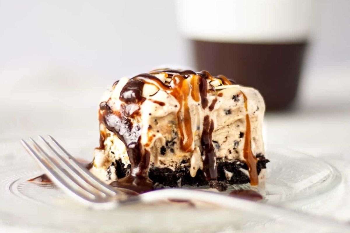A piece of ice cream with caramel sauce and a fork on a plate.
Keywords: Recipes.
