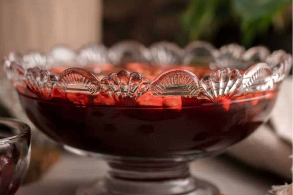 A glass bowl of cranberry chutney sitting on a table, perfect for holiday recipes.