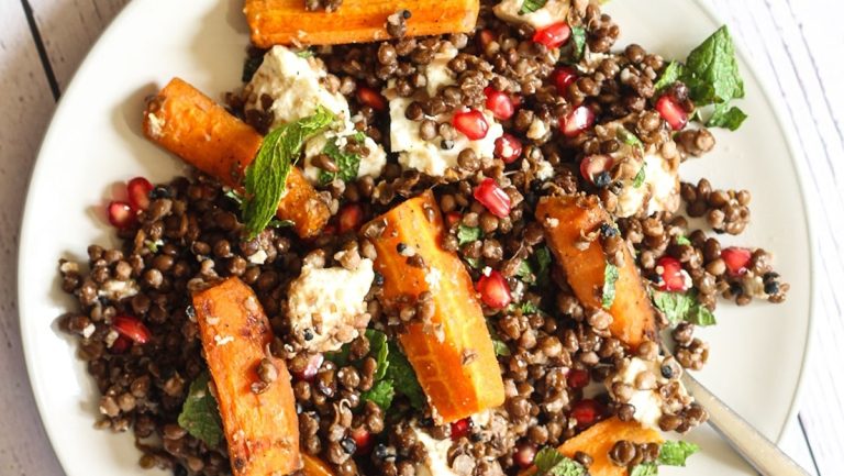 A plate of lentil salad with pomegranate and feta, perfect for pomegranate lovers looking for new recipes.