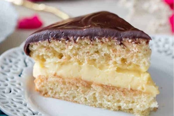 A slice of chocolate cake on a white plate.