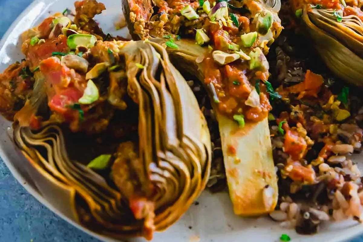 Stuffed artichokes with meat, rice, and pistachio recipes on a plate.