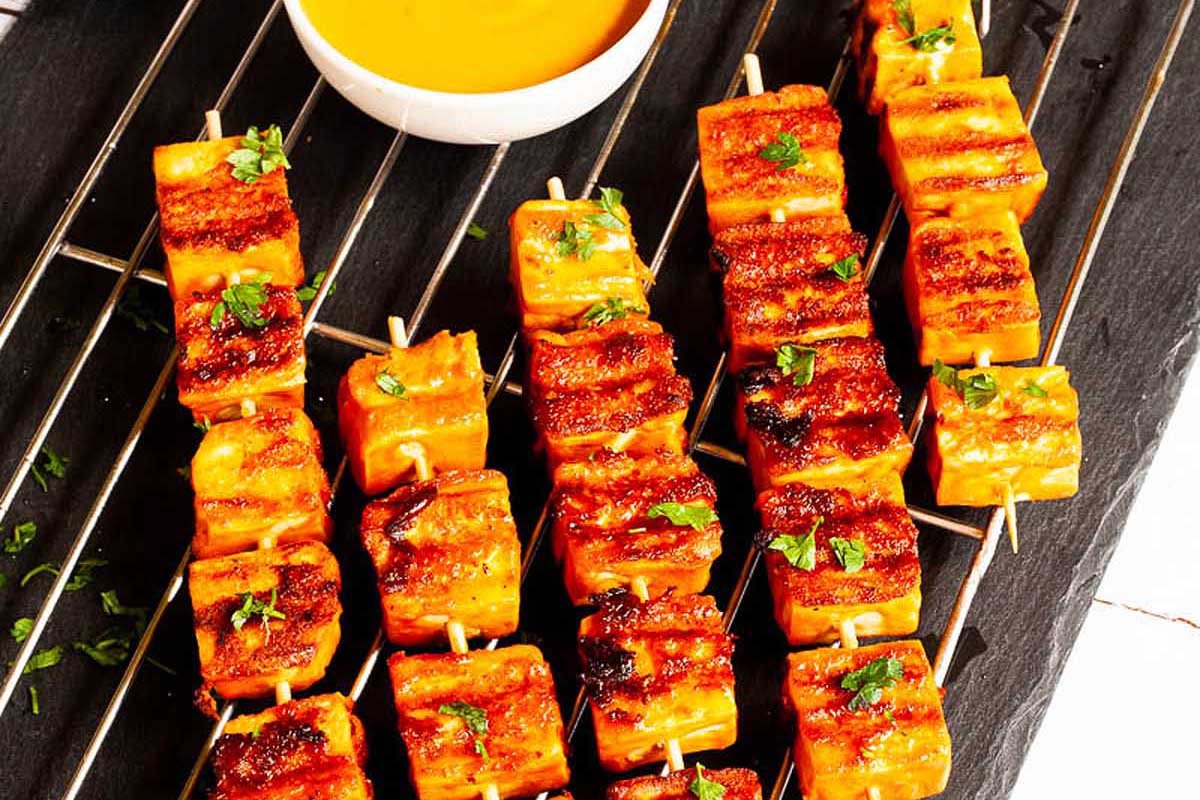 A tray of skewers coated in sauce.