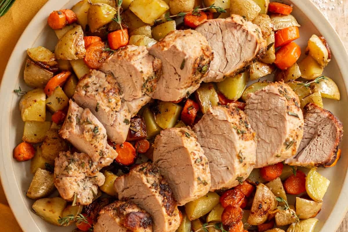 Delicious dinners featuring roasted pork with carrots and potatoes on a plate.