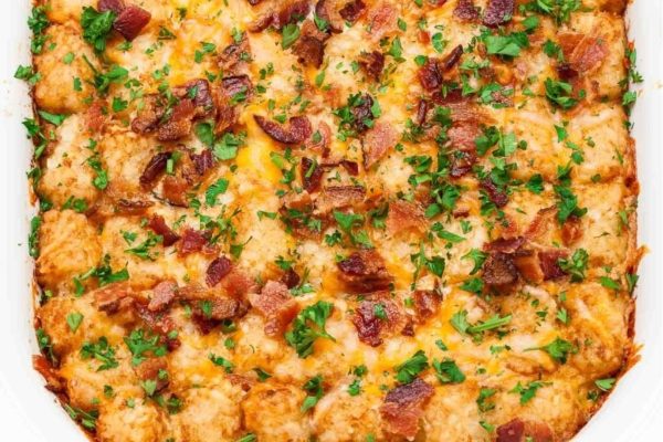 A casserole dish topped with bacon and cheese.