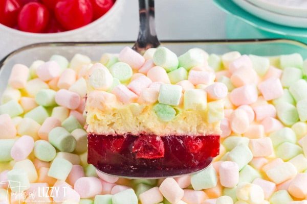A dessert dish with marshmallows and strawberries on top, perfect for recipes or jello lovers.