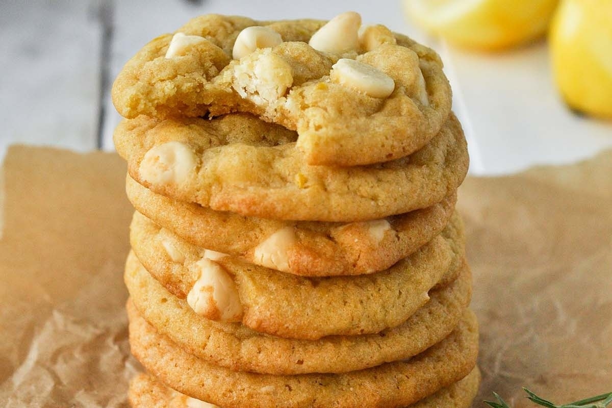 A stack of lemon cookies on top of a white chocolate paper.