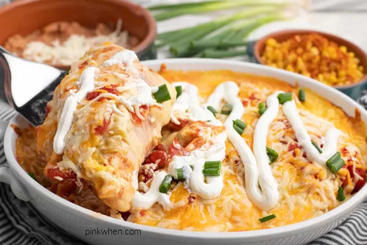 Chicken enchilada casserole in a white dish.