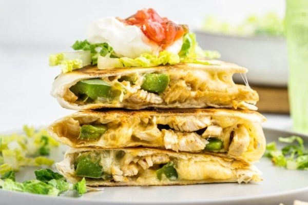 A stack of chicken quesadillas on a plate.