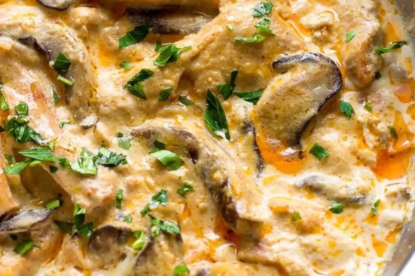 A skillet filled with mushrooms and cream sauce.