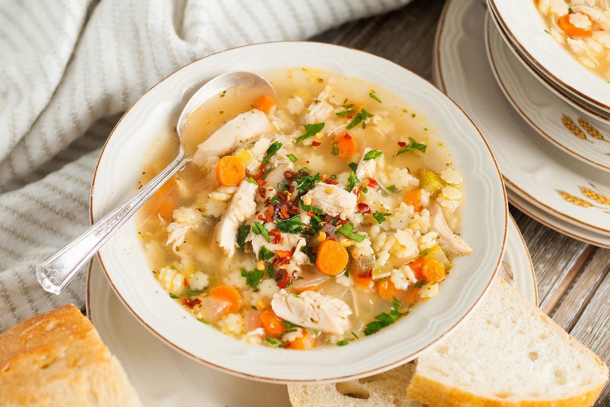Fresh and Tasty Spring Comfort Food Ideas 8 A bowl of chicken and rice soup on a wooden table.