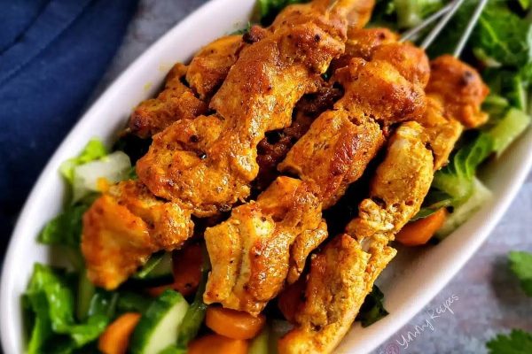 Parents love these kid-friendly chicken skewers on a white plate.