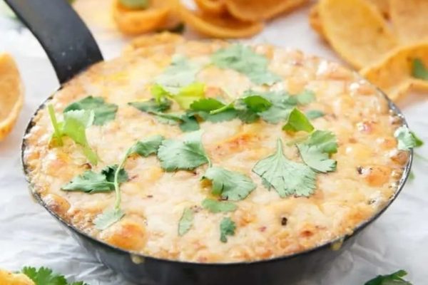 Mexican cheese dip in a skillet with tortilla chips.