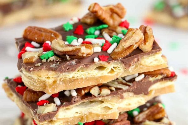 A stack of chocolate and pecan bars with sprinkles on top, perfect for Christmas desserts.