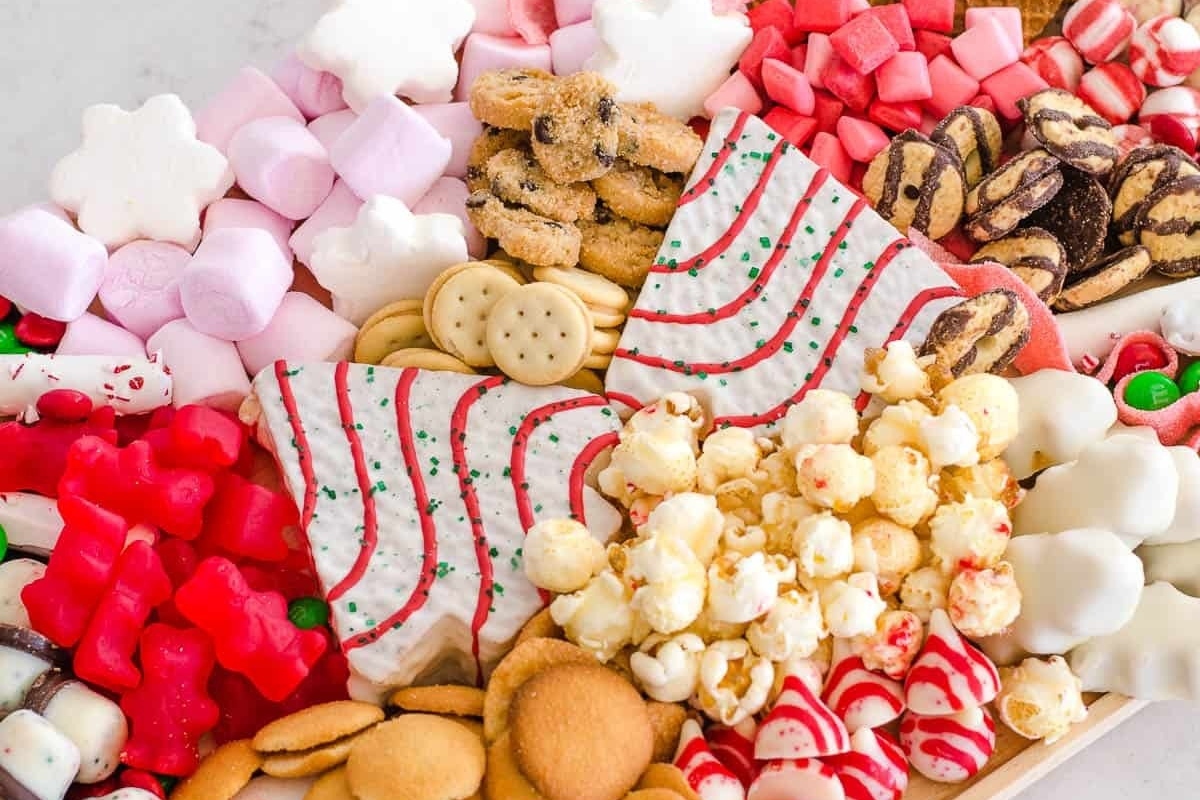 A festive tray filled with an assortment of Christmas cookies and candies, resembling a delicious charcuterie board.