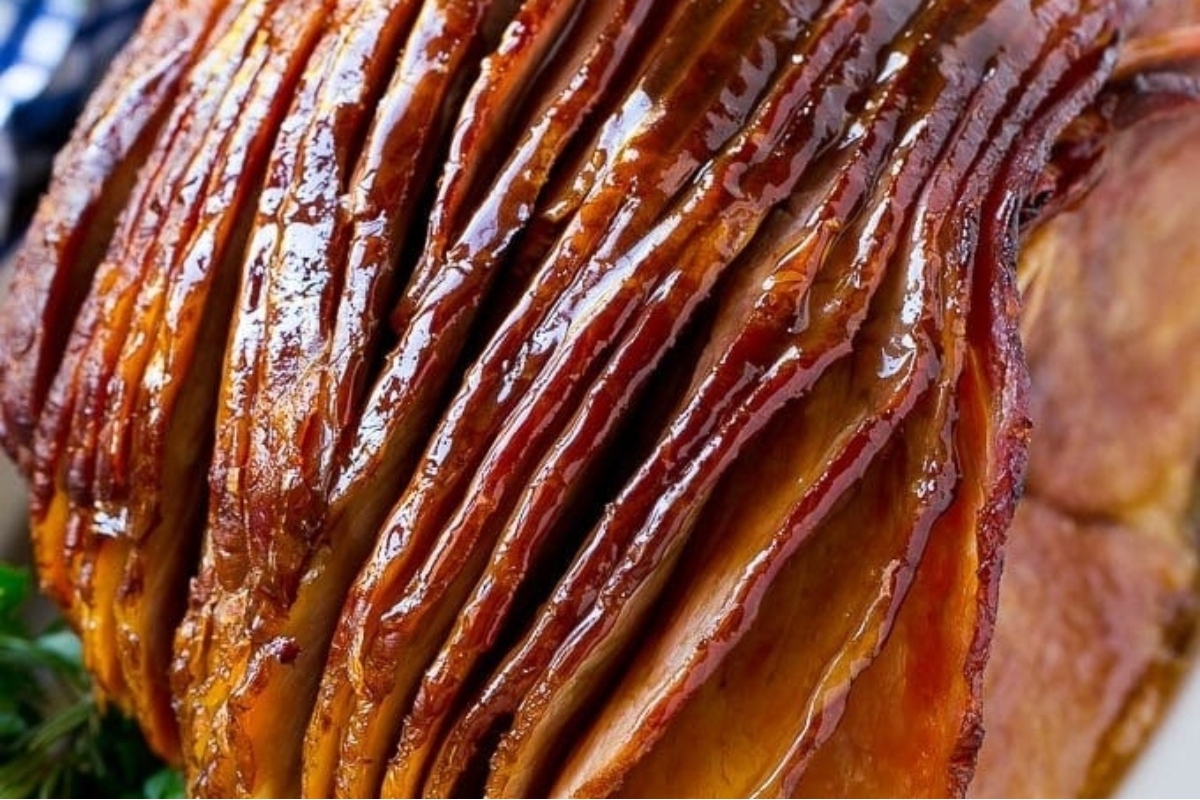 A country-style ham that has been sliced and placed on a plate.